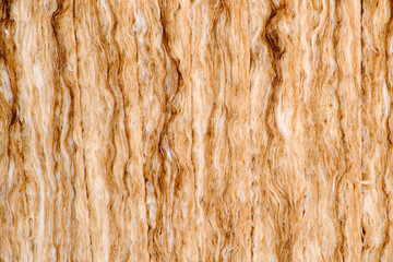 Background of yellow glass wool, texture of insulation material close-up