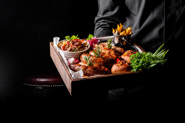 chef or waiter hold Set with various meat Bavarian, Frankfurt, German grilled sausages, Oktoberfest food