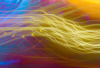 An abstract picture of light streaks on a dark blue purple background