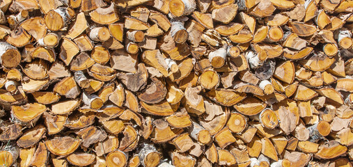 Chopped and stacked pile of pine and birch wood. Texture, background