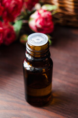 Small bottle with essential oil. Aromatherapy and herbal medicine concept. Selective focus. Wooden background.
