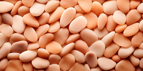 Fototapeta na wymiar A close up of a pile of brown and white pebbles, peach fuzz, color of the year 2024, monochromatic image