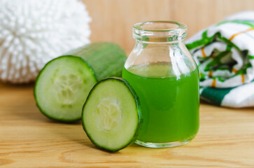 Small bottle with cucumber juice for preparing homemade facial mask, face toner or eye mask. Natural beauty treatment and spa recipe.