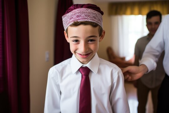 boy getting ready for bar mitzvah with traditional attire