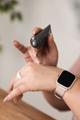 The girl applies foundation to the skin of her hand