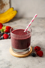 Glass of berry smoothie in a glass. Strawberry, banana, blueberry healthy drink. 