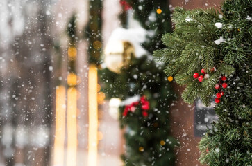 Winter. Snow is falling. Beautiful holiday decorations on the street in the city. Beautiful...