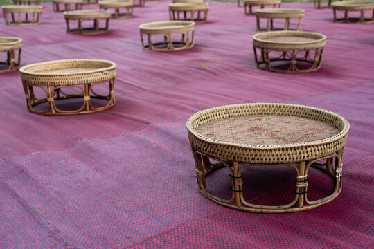 Row of Khantok (food tray) made from rattan, kind of wooden utensil in northern Thailand for placing Thai food traditionally dinner for homestay Chiang Mai, Thailand