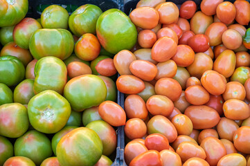 Tomatoes of two kinds or variations grown in local gardens and for sale at a street market