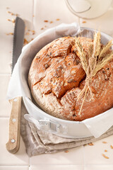 Homemade loaf of round bread in a bright spring kitchen.