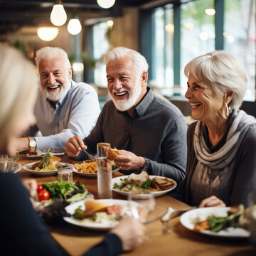 elderly friends eating dinner in restaurant.