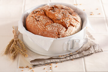 Homemade loaf of round bread baked with homemade flour.