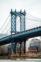 Suspension bridge over river in modern city district