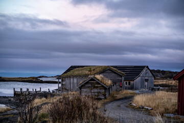 fisherman wooden cabins on coast of norwegian sea with mountains on background