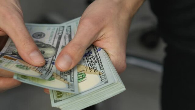 Focus on dollar bills and the importance of careful financial planning in one video created for successful people. The rise and fall of the dollar and the financial market. Salary and investments.