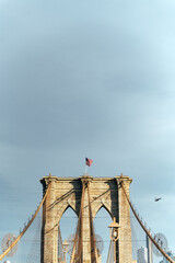 Fototapeta premium Brooklyn Bridge with waving American flag