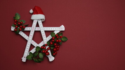 Santa's hat on the folding rule. Christmas and New Year concept for construction companies