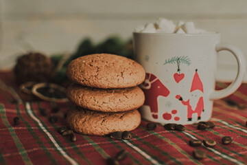 a mug with a Christmas pattern full of marshmallows. a Christmas card. cookies and slices of lemon and orange. festive drawing