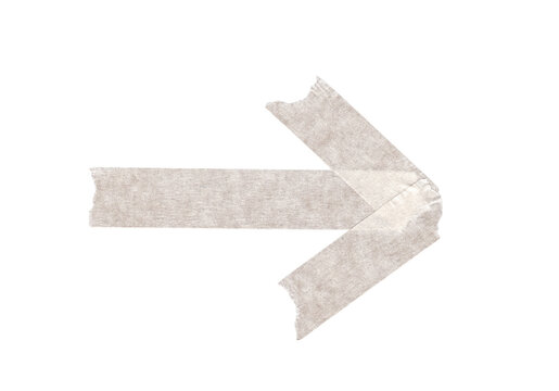 torn piece of adhesive masking tape in the shape of a directional arrow on transparent background