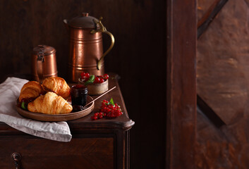 traditional breakfast of croissants, coffee and fresh berries