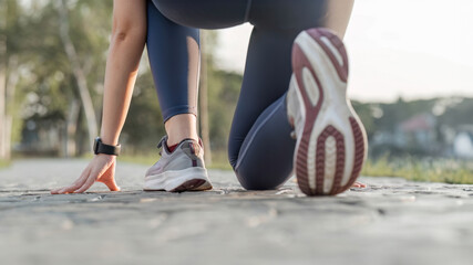 Close-up photo of women is sports shoes Get ready for a run on a bright spring day. - obrazy, fototapety, plakaty