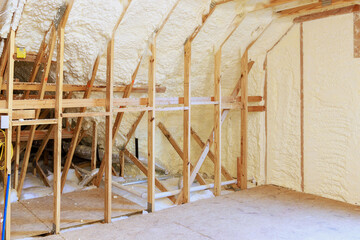 Wall in new home under construction is made up of spray foam thermal hydro insulation