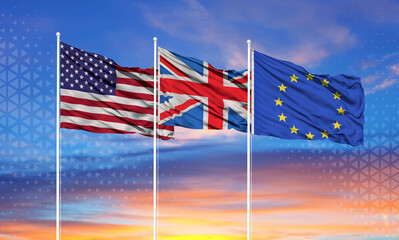 Three realistic flags of European Union, United States and United Kingdom on flagpoles and blue sky.