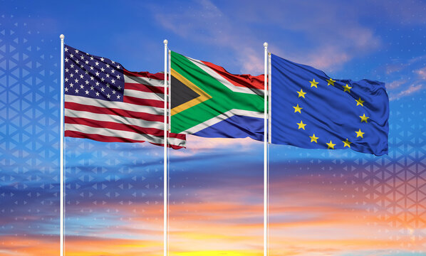 Three realistic flags of European Union, United States and South Africa on flagpoles and blue sky.