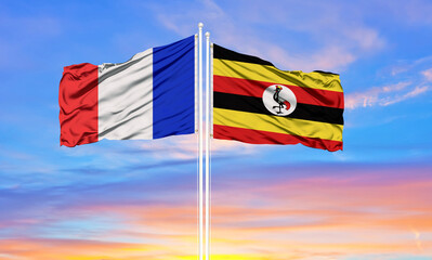 France and angola two flags on flagpoles and blue sky.
