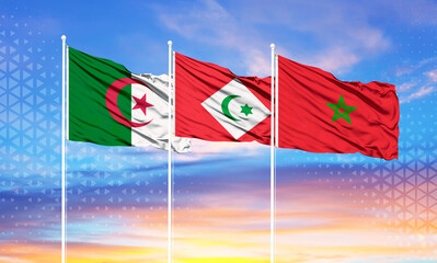 flags of morocco, algeria and rif on flagpoles and blue sky.