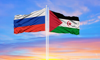 Russia and western sahara two flags on flagpoles and blue sky.