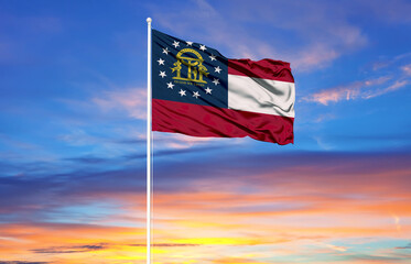 Georgia  flag on flagpoles and blue sky.