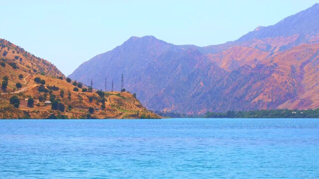 Beautiful view of Nurek river with blue lake and high mountains against the sky