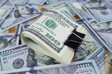 Fototapeta premium dollars with metal clip on dollars background.