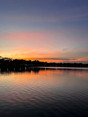 Naklejka premium Evening golden hour sunset near Bedok reservoir with the view of trees, cloud and home residents