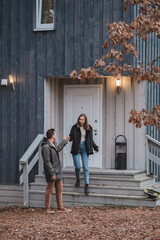 Young stylish couple walking down the stairs of their barn style home