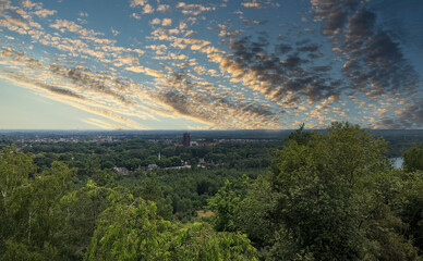 This image presents a captivating view from a high vantage point overlooking a suburban landscape...