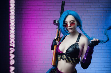 sexy girl in a bright image of a super hero with a retro Thompson machine gun in her hands on a neon background of brick texture