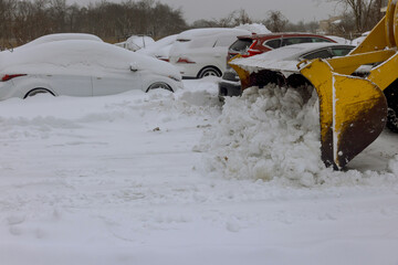 It is common for snowplow trucks to remove snow from parking lots following heavy snowfall