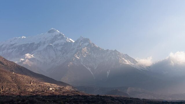 Time lapse of clouds at dawn over mountain Dhaulagiri in the himalaya Nepal near Jomsom