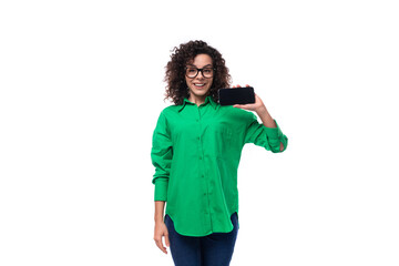 well-groomed young female marketing employee with black hair dressed in a green shirt showing a...