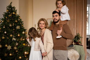 Obraz na płótnie Canvas happy family enjoying their time together at home near Christmas tree