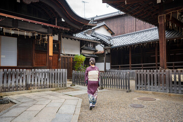Japanese Kimono Portrait back view photography. Kyoto, Japan. Japanese traditional buildings background.