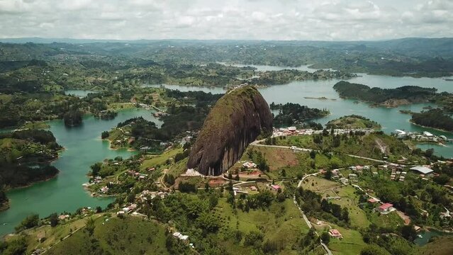 Aerial drone footage of El Penon de Guatape near Medellin in Antioquia, Colombia. Large and unique alone rock with stairs to the top, touristic place. Big stone in Colombia. High quality 4k footage.
