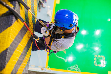 Top view male worker training  rope access