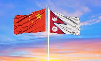 Nepal and China flag waving in the wind against white cloudy blue sky together. Diplomacy concept, international relations