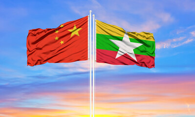 Flag of China and Myanmar waving in the wind against white cloudy blue sky together. Diplomacy concept, international relations