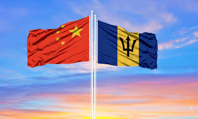 Flag of China and Barbados waving in the wind against white cloudy blue sky together. Diplomacy concept, international relations