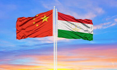 Flag of China and Tajikistan waving in the wind against white cloudy blue sky together. Diplomacy concept, international relations