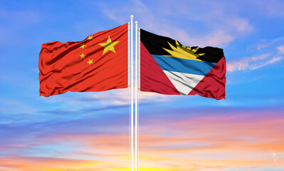 Flag of China and Antigua and Barbuda waving in the wind against white cloudy blue sky together. Diplomacy concept, international relations